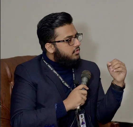 Winston speaking with a microphone at the Aethir IRL event in Pakistan
